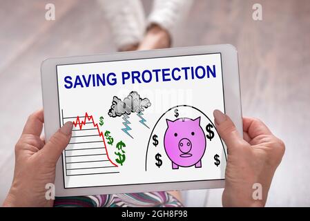 Saving protection concept shown on a tablet held by a woman Stock Photo