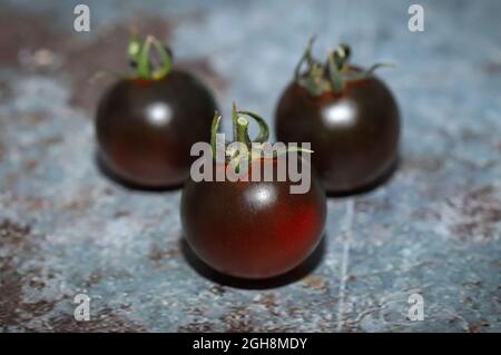 Black tomatoes in the table Stock Photo