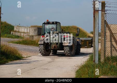 British army JCB fork lift truck moving boxed weapons in preparation for next military exercise, Wiltshire UK Stock Photo