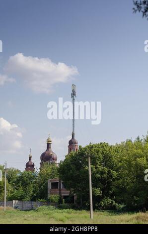 Unusual perspective of the tower 5g and the church. The communic Stock Photo