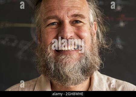 close-up of the face of the smiling middle-aged man looking into the camera. Stock Photo