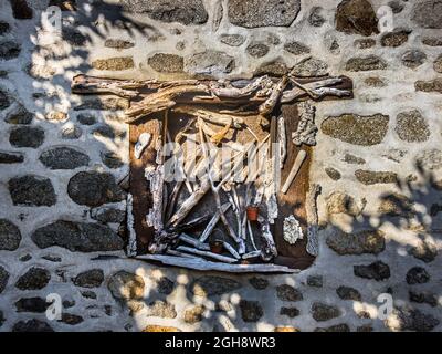 Assembly of old sticks made into artwork in wall niche - Bénévent-l'Abbaye, Creuse (23), Nouvelle-Aquitaine, France. Stock Photo
