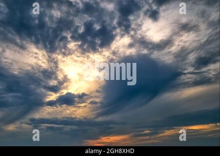 Dark cloudy sky at sunset in sunshine - abstract background Stock Photo