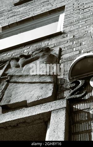 A black and white image of a brick wall facade from a low angle Stock Photo