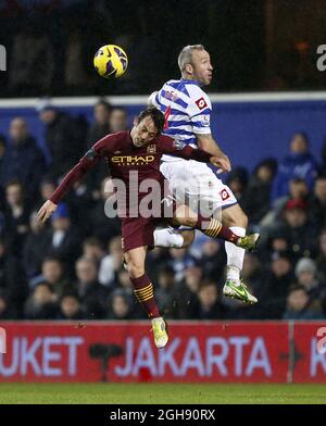 QPR's Shaun Derry tussles with Manchester City's David Silva during the Barclays Premier League between QPR and Manchester City at the Loftus Road in London on January 29, 2013. Stock Photo