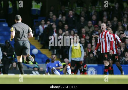 Chelsea's Ashley Cole feigns injury to the annoyance of Brentford's players during the FA Cup, Fourth Round Replay between Chelsea and Brentford at the Stamford Bridge in London on February 17, 2013. Stock Photo