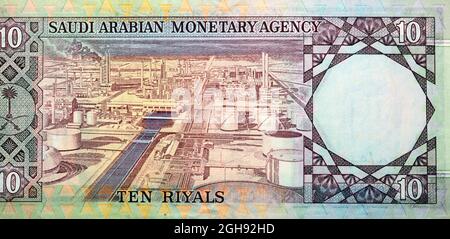 Large fragment of the reverse side of 10 ten Saudi riyals banknote currency issued 1961 to 1977 by Saudi Arabian Monetary Agency with an oil refinery Stock Photo