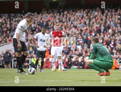 Arsenal goalkeeper Wojciech Szczesny attempts to distract Robin van Persie prior to his penalty kick during the Barclays Premier League match between Arsenal and Manchester United in Emirates Stadium, London on April 28, 2013. Stock Photo