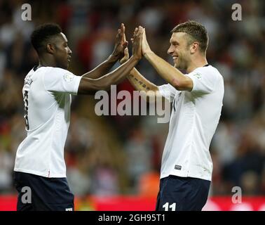 England's Danny Welbeck celebrates scoring his sides fourth goal with Rickie Lambert during the 2014 FIFA World Cup Qualifier, Group H match between England and Moldova at the Wembley Stadium in London on September 6, 2013. Stock Photo