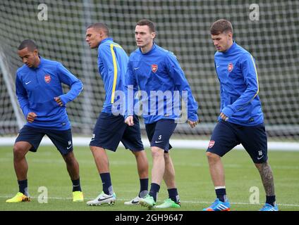 Arsenal's Thomas Vermaelen, Theo Walcott and Kieran Gibbs during a training session on the UEFA Champions League match at London Colney in London, England on September 17, 2013. David Klein Stock Photo