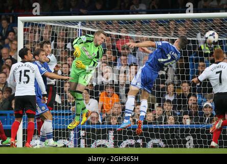 Fulham s David Stockdale watches as Chelsea s Gary Cahill misses the ball during the Barclays Premier League match between Chelsea and Fulham at Stamford Bridge Stadium in London UK on September 21 20...