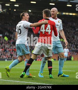 Mark Noble of West Ham United and James Collins of West Ham United react to a dive by Adnan Januzaj of Manchester United during the Barclays Premier League match between Manchester United and West Ham United held at Old Trafford Stadium in Manchester, England on 21st December 2013. Photo by: Simon Bellis. Stock Photo