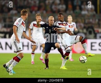 Germany's Jerome Boateng tussles with Scotland's Steven Naismith during the UEFA Euro 2016 Qualifying, Group D match between Germany and Scotland at the Signal Iduna Park, Dortmund on September 7, 2014. Stock Photo
