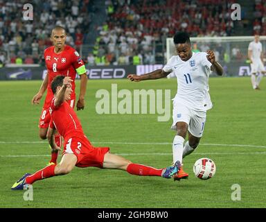 Switzerland's Johan Djourou tussles with England's Raheem Sterling during the UEFA Euro 2016 Qualifying Group E match between Switzerland and England held at the St Jakob Park in Switzerland on September 8, 2014.Picture David Klein/Sportimage. Stock Photo