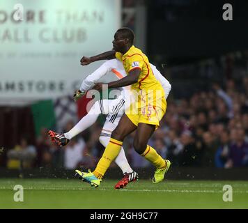 West Ham's Adrian gets caught late by Liverpool's Mario Balotelli during the Barclays Premier League match between West Ham United and Liverpool held at the Upton Park in London, England on September 20, 2014. Stock Photo