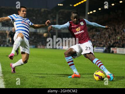 QPR's Mauricio Isla tussles with Aston Villa's Aly Cissokho during the Barclays Premier League match between Queens Park Rangers and Aston Villa at the Loftus Road in England on October 27, 2014. Stock Photo