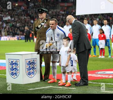 England's Wayne Rooney gets presented with his 100th cap during the UEFA Euro 2016 match between England and Slovenia in Wembley Stadium, London , England on 15th November 2014. Stock Photo