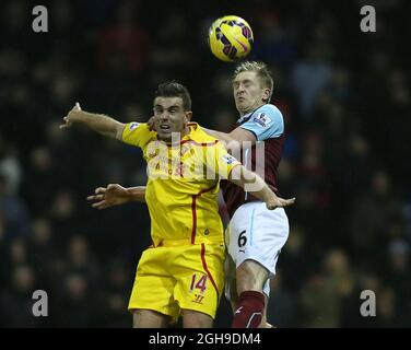 Jordan Henderson of Liverpool tussles with Ben Mee of Burnley During the Barclays Premier League match between Burnley and Liverpool at the Turf Moor Stadium in Burnley, England on December 26, 2014. Simon Bellis Stock Photo