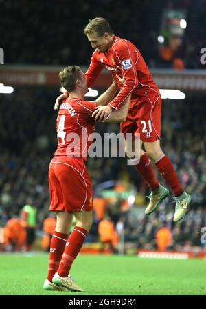 Jordan Henderson of Liverpool and Lucas Leiva of Liverpool celebrate the own goal during the Barclays Premier League match between Liverpool and Swansea City at Anfield Stadium, England on December 29, 2014. Stock Photo