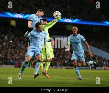 James Milner and Martin Demichelis of Manchester City combine to keep the ball away from Lionel Messi of Barcelona during the UEFA Champions League Round of 16 match between Manchester City and Barcelona at the Etihad Stadium, London on 24th February 2015. Stock Photo