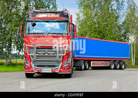 New beautifully customised Volvo FH16 grain truck with hopper trailer parked on the asphalt yard of Pernio granary. Salo, Finland. August 29, 2021. Stock Photo