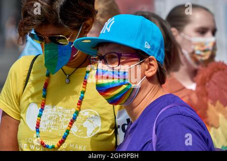 Braunschweig, Germany, August 14, 2021: Two middle-aged women with face masks in the colors of the rainbow at CSD, Christopher Street day Stock Photo