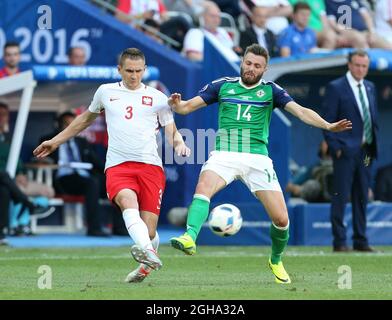 Poland's Artur Jedrzejczyk tussles with Northern Ireland's Stuart Dallas during the UEFA European Championship 2016 match at the Allianz Riviera, Nice. Picture date June 12th, 2016 Pic David Klein/Sportimage via PA Images Stock Photo