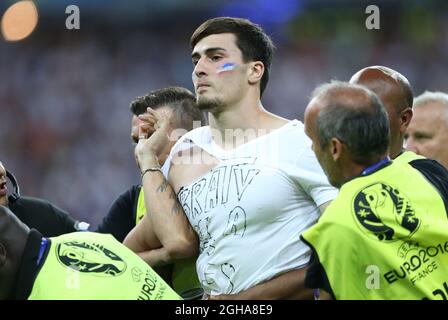 A pitch invader is escorted off the pitch during the UEFA European Championship 2016 final match at the Stade de France, Paris. Picture date July 10th, 2016 Pic David Klein/Sportimage via PA Images Stock Photo