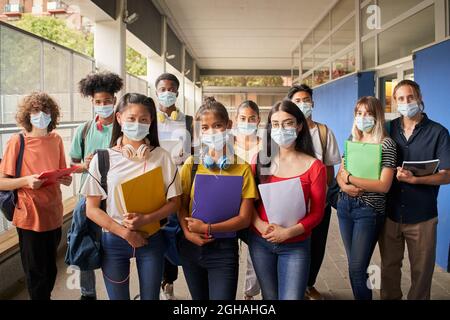 Portrait of a group of students in face mask looking at the camera. Back to school. Stock Photo