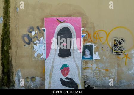 Detail of a graffiti wall with different street artworks (paste up, stencil art) in the New Venice district, old town of Livorno, Tuscany, Italy Stock Photo