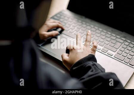 Midsection of boy playing game on laptop at home Stock Photo