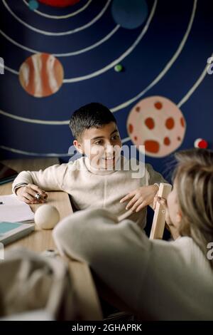Happy son talking with mother at home Stock Photo