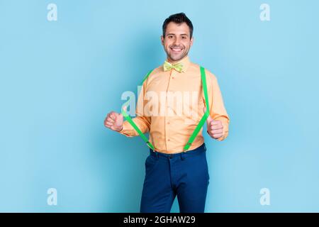 Photo of trend brunet man wear peach shirt pants isolated on blue color background Stock Photo