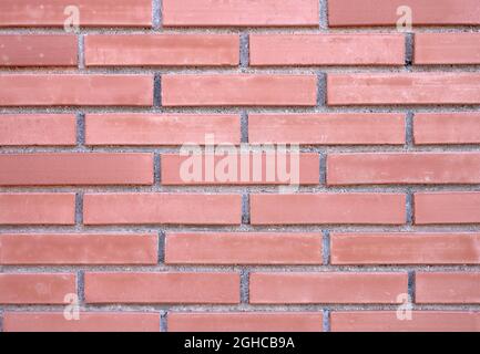 detail of a wall of red and brown bricks with mortar Stock Photo