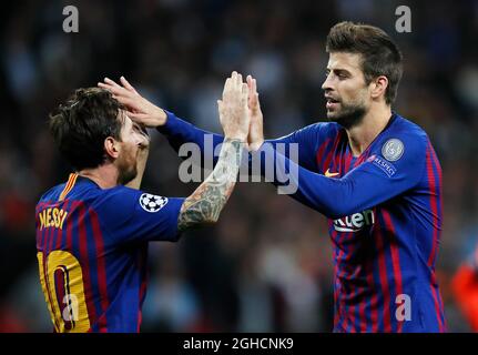 Barcelona's Lionel Messi celebrates with Gerard Pique after scoring his teams fourth goal during the UEFA Champions League Group B  match at Wembley Stadium, London. Picture date: 3rd October 2018. Picture credit should read: David Kein/Sportimage Stock Photo