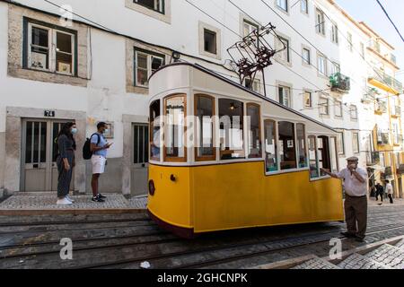 Lisbon, Portugal. 01st Sep, 2021. People are seen next to the Bica funicular, in Lisbon.The Bica funicular was inaugurated in 1892 as a link between 'Largo do Calhariz' Square and 'Rua de Sao Paulo' Street. It worked with the rack rail and water counterbalance system and later with steam. The funicular was then electrified in 1927 and classified as a national monument in 2002. (Photo by Hugo Amaral/SOPA Images/Sipa USA) Credit: Sipa USA/Alamy Live News Stock Photo