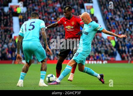 Newcastle United's Jonjo Shelvey tackles Manchester United's Paul Pogba during the Premier League match at the Old Trafford Stadium, Manchester. Picture date 6th October 2018. Picture credit should read: Matt McNulty/Sportimage via PA Images Stock Photo