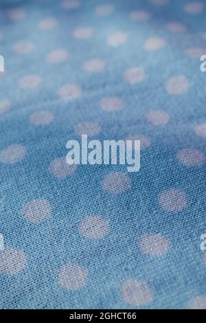 Close up of blue and pink knitted wool texture of a sweater with white circles Stock Photo