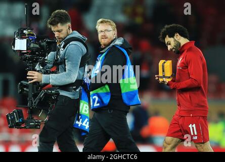 Liverpool's Mohamed Salah exchanges his shirt with a member of the crowd  for a present after the UEFA Champions League, Group C match at Anfield,  Liverpool Stock Photo - Alamy