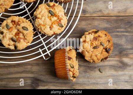 Pumpkin muffins with crumble and seeds topping on a rustic wooden table Stock Photo