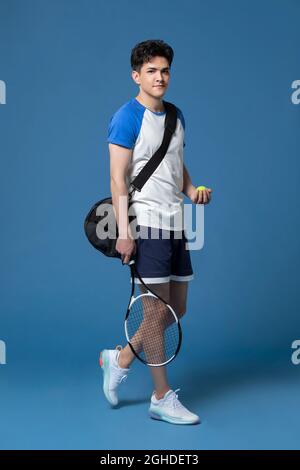 Studio shot of young man playing tennis Stock Photo