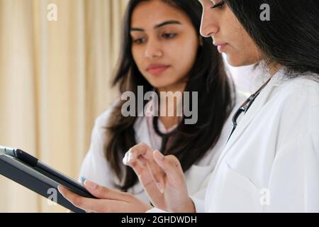 Female South Asian doctors from India talking to each other Stock Photo