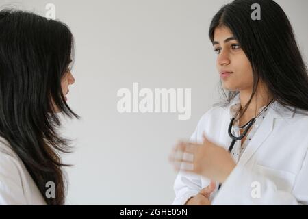 Female South Asian doctors from India talking to each other Stock Photo