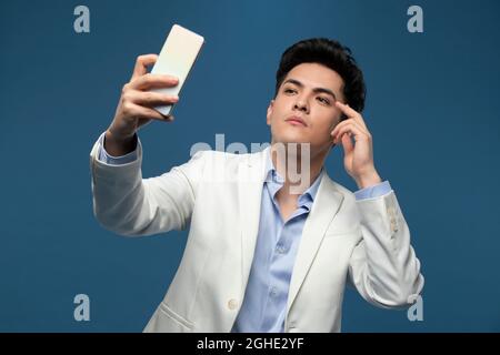 Fashionable young man using smart phone Stock Photo