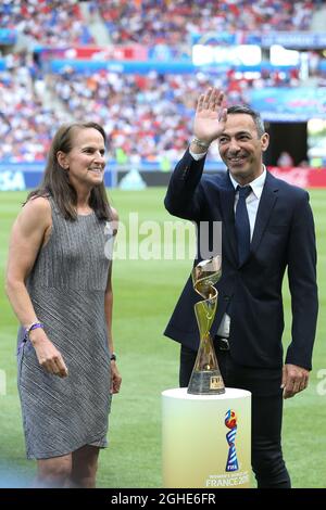 Carla Overbeck ( Actual assistant manager of Duke University and former USA player and Winner of the first ever Women's World Cup in 1991 ) presents the Women's FIFA World Cup with Youri Djorkaeff ( Former French National team player and Winner of the FIFA World Cup in 1998 ) during the FIFA Women's World Cup match at Stade de Lyon, Lyon. Picture date: 7th July 2019. Picture credit should read: Jonathan Moscrop/Sportimage via PA Images Stock Photo