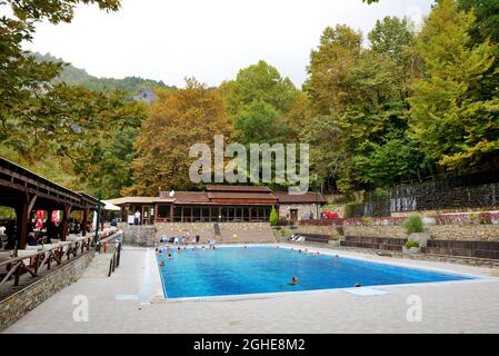LOUTRA, ARIDEA, GREECE-OCTOBER 13: The tourists swimming in water from hot springs in Loutra, Aridea on October 13, 2013 in Loutra, Aridea, Greece. Up Stock Photo
