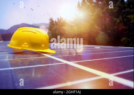 Helmet over installed solar panels on the roof Stock Photo