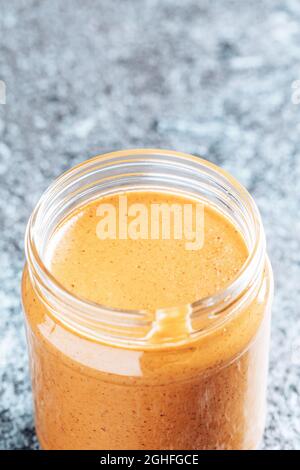 Crunchy peanut butter in a glass jar. Stock Photo