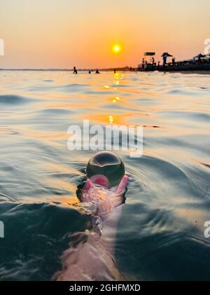 Beautiful scenic view through lens of crystal ball at summer sunset.  Stock Photo