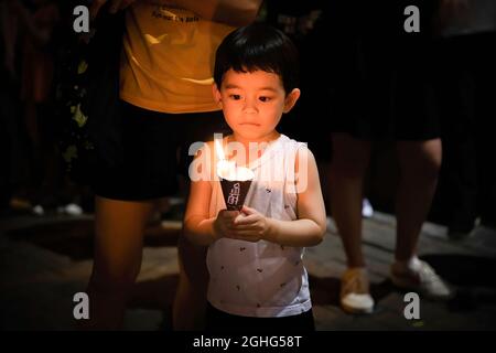 Hong Kong, China. 4th June, 2020. A child holds a lit candle in memory of the Tiananmen Massacre.Amid covid-19 pandemic in Hong Kong, the Annual June 4 Vigil which was once a significant cornerstone for Hong Kong democratic environment, and has been held for 31 years has been put to a stop as police banned the event in 2020, and the organiser behind the vigil is facing disband. (Credit Image: © Alex Chan Tsz Yuk/SOPA Images via ZUMA Press Wire) Stock Photo